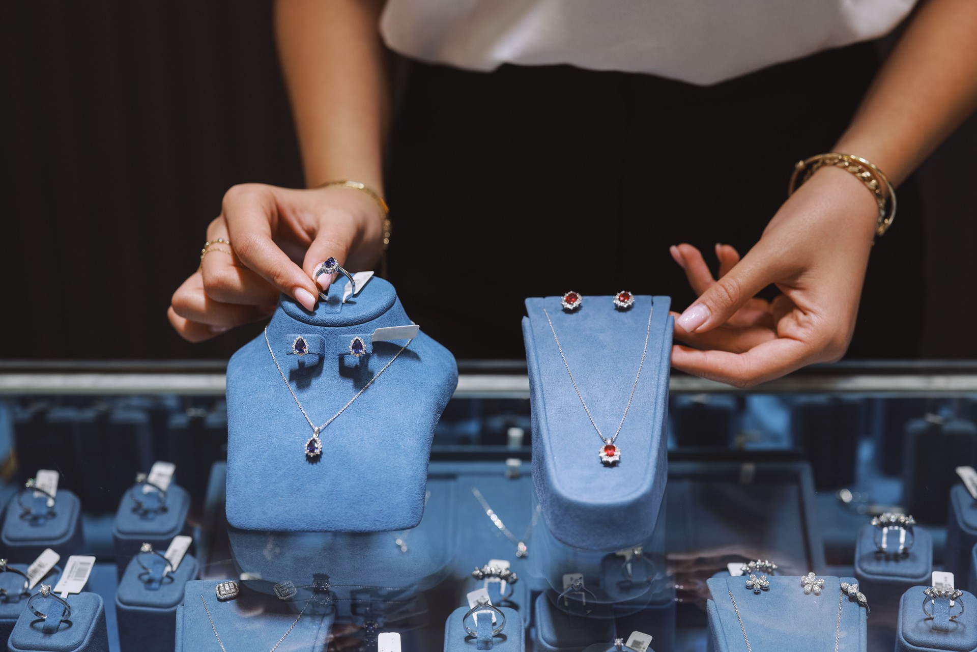 Woman owner of jewelry shop presenting necklace