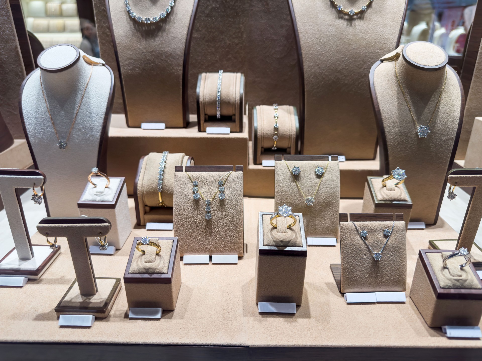 Golden pendants and earring with dimonds on display of jewelry store